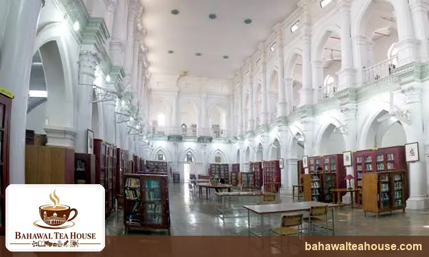 Grand reading hall with white arches and bookshelves in Bahawalpur Central Library